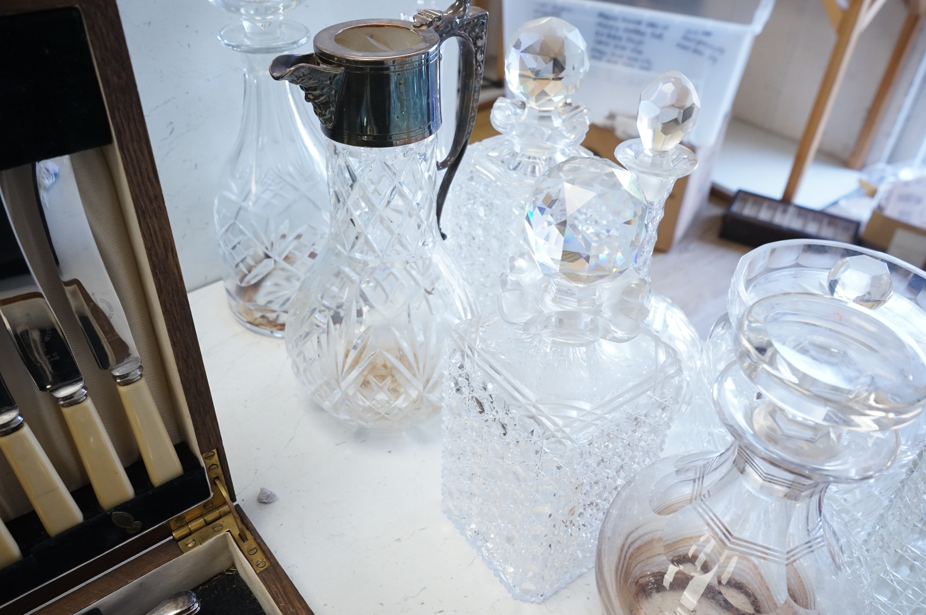 A collection of various cut glass to include decanters and a small pedestal bowl, largest 30cm high